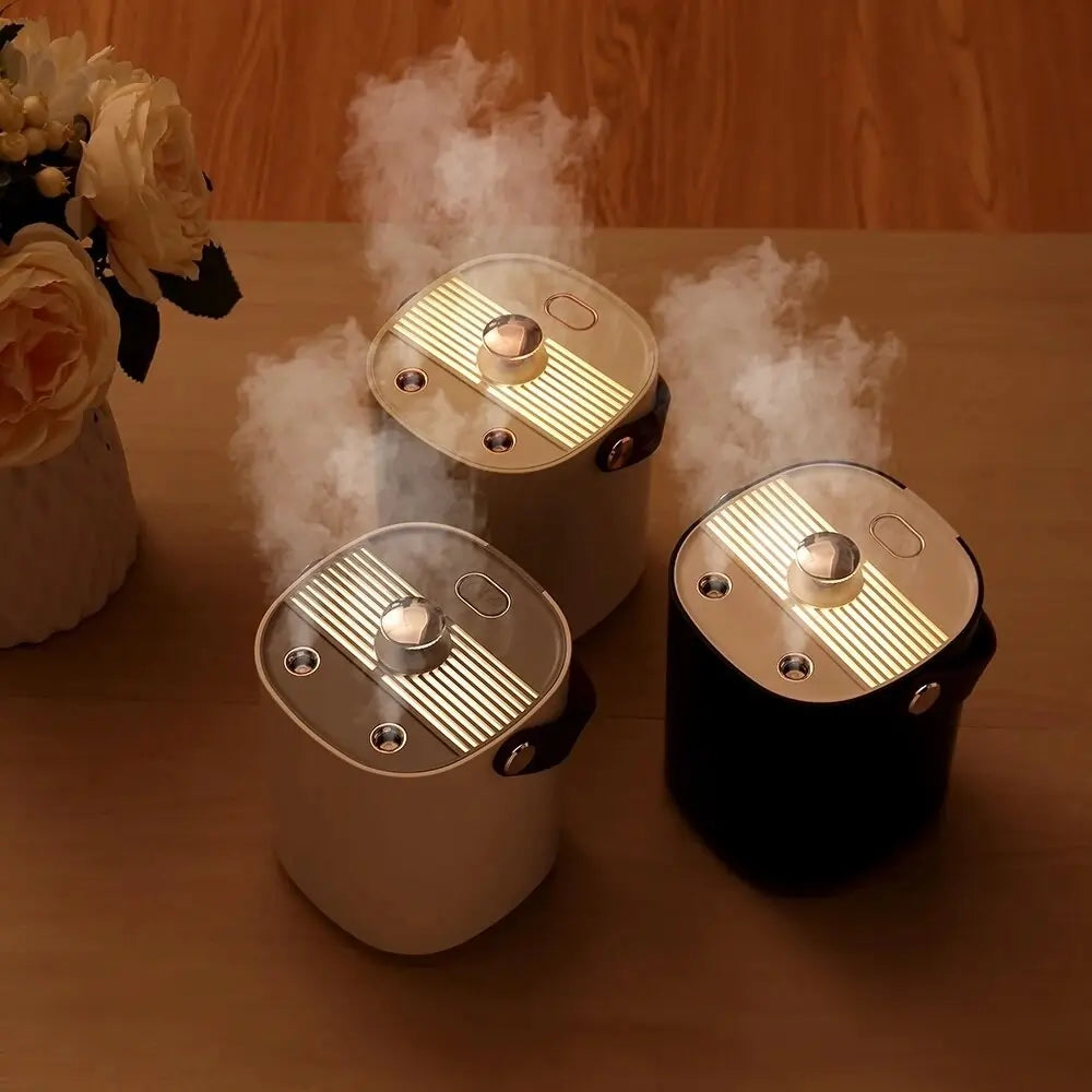 Three humidifiers emitting mist on a wooden surface with flowers in the background